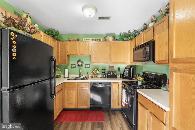 a kitchen with a sink appliances and cabinets