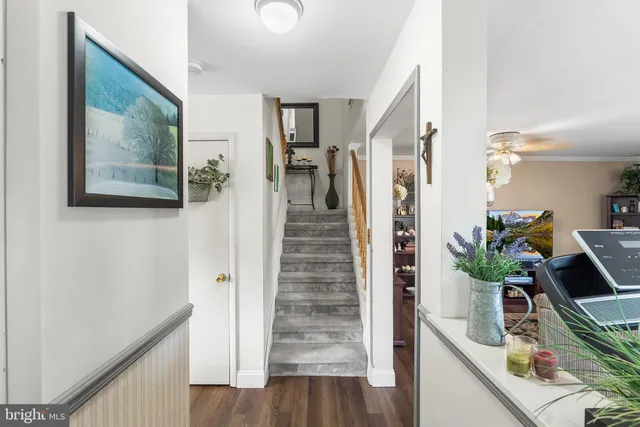 a view of a hallway with wooden floor and staircase