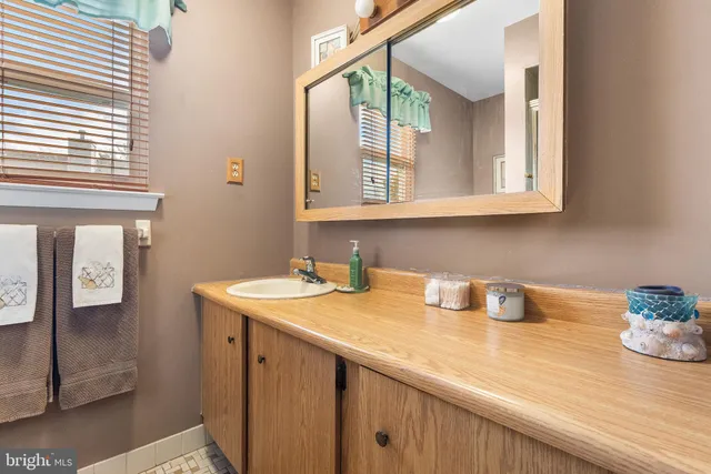 a kitchen with a sink cabinets and a window