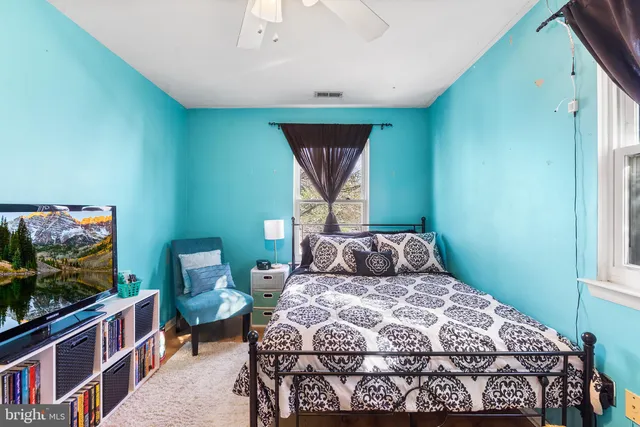 a bedroom with a bed and flat screen tv