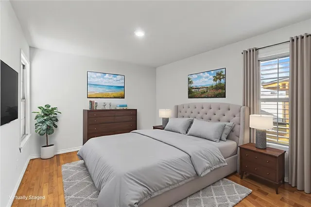 a bedroom with a bed and a potted plant