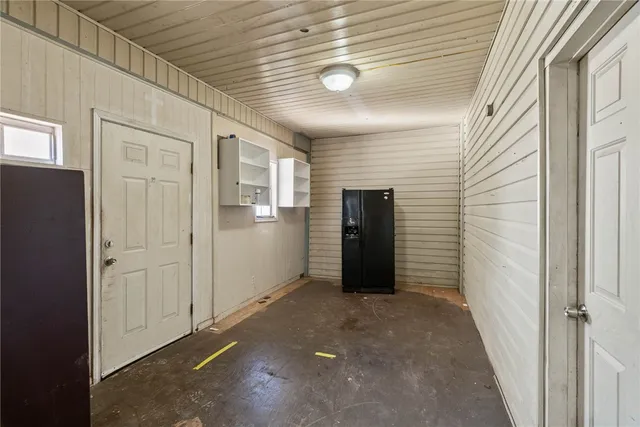 a view of entryway with wooden walls