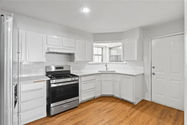 a kitchen with a sink cabinets and stainless steel appliances