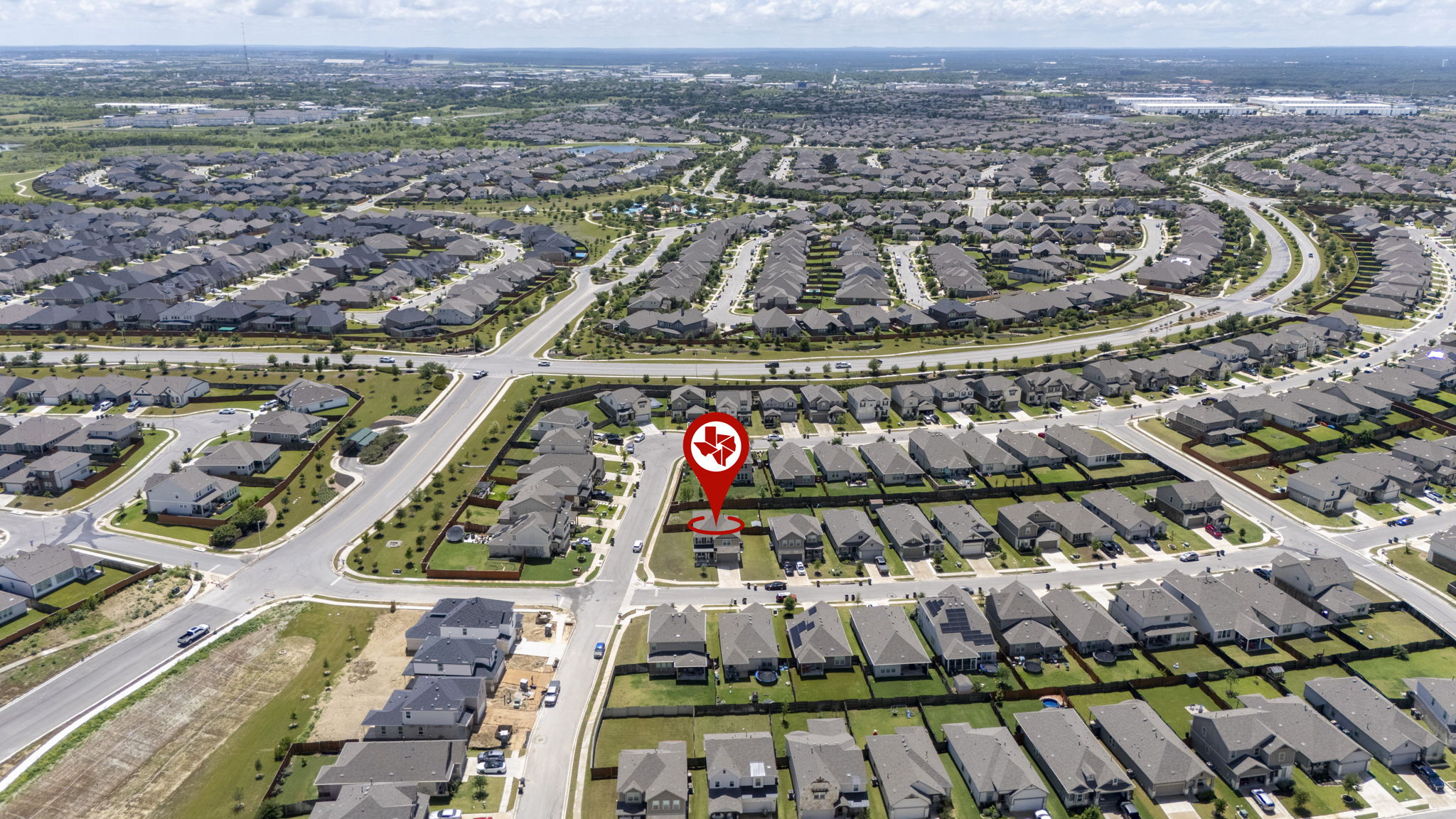 548 Purple Heart Drive Buda, TX 78610 - Photo 29 of 35 An aerial perspective reveals the vast, well-planned layout of a modern suburban neighborhood.