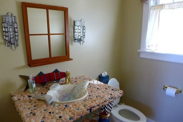 99 Pond Road West Tisbury, MA 02568 - Photo 15 of 39 a bed sitting in a bedroom next to a window