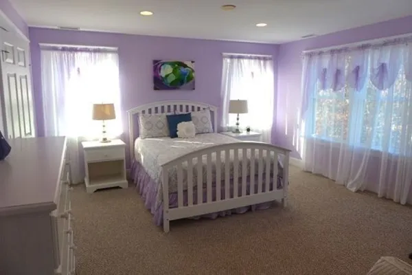 a bedroom with a bed table and a window