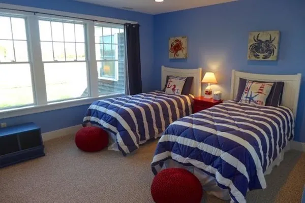 a bedroom with two beds and a window