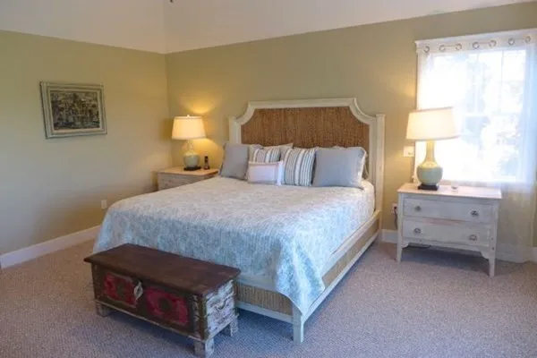 a bedroom with a bed and a night stand