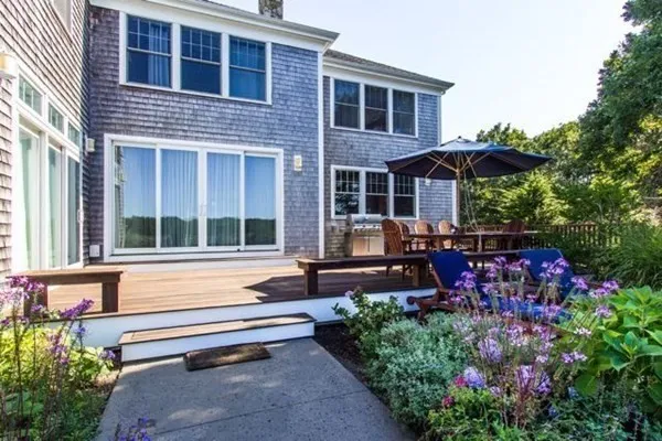 a wooden bench sitting in front of a house