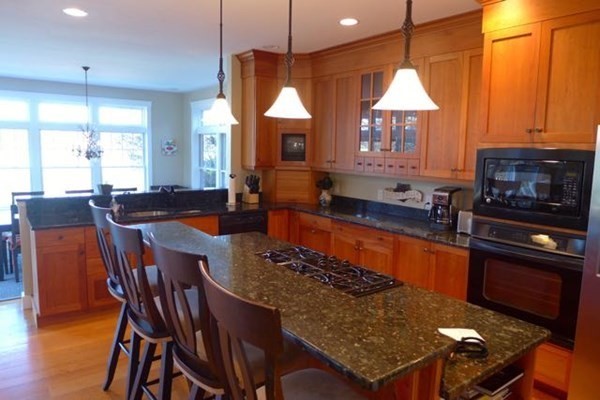 99 Pond Road West Tisbury, MA 02568 - Photo 6 of 39 a kitchen with stainless steel appliances granite countertop a sink a stove a table and chairs