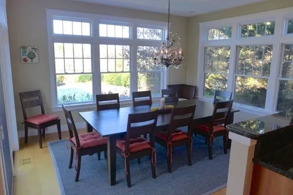a view of a dining room with furniture wooden floor and a chandelier