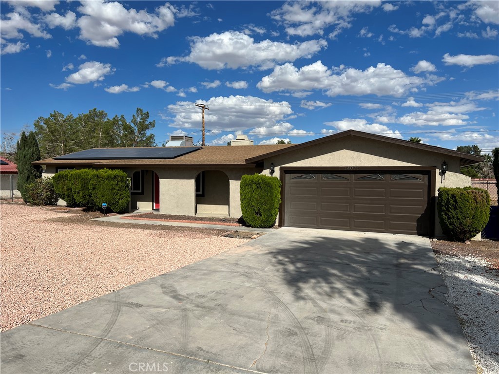 14075 Crow Road Apple Valley, CA 92307 - Photo 1 of 1 a front view of a house with a yard and garage