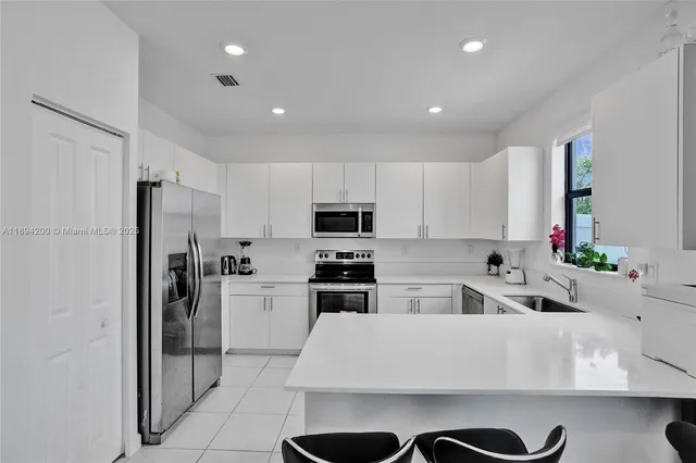 a kitchen with a sink stainless steel appliances and cabinets