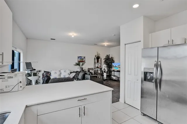 a kitchen with a refrigerator and a sink