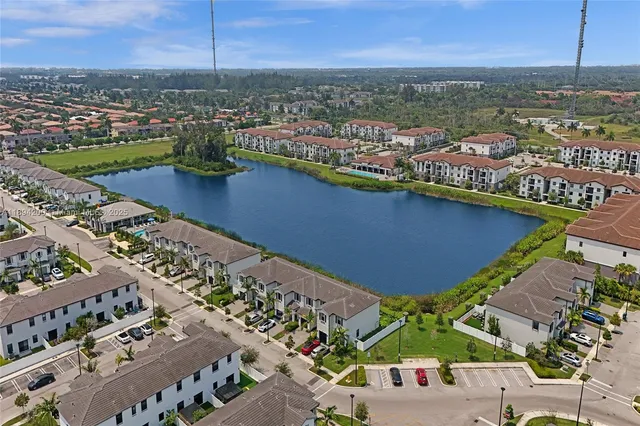 an aerial view of residential building and lake
