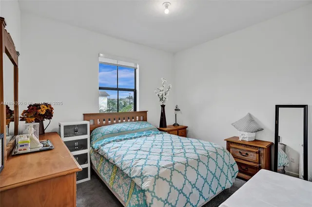 a bedroom with a bed and a dresser