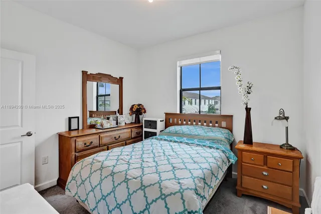 a bedroom with a bed and a dresser in it