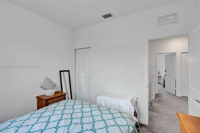 a bedroom with a bed and a desk