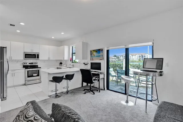 a view of a livingroom with workspace and a window