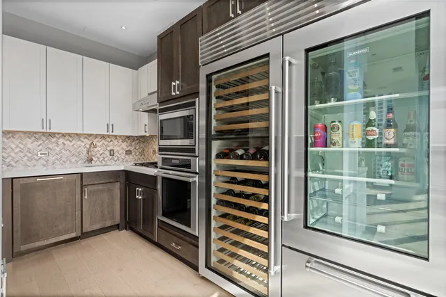 a kitchen with stainless steel appliances granite countertop a granite counter tops and a view of living room
