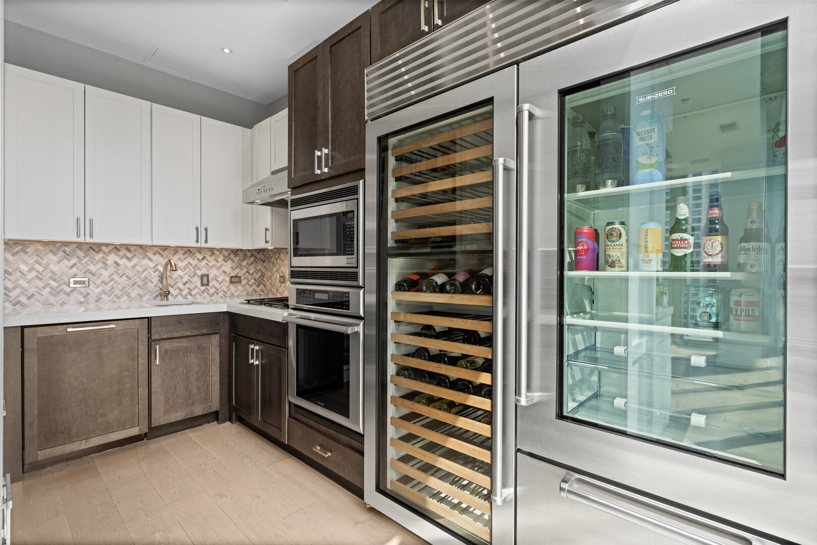 550 North St Clair Street, Unit 2502 Chicago, IL 60611 - Photo 13 of 53 a kitchen with granite countertop a refrigerator and a sink