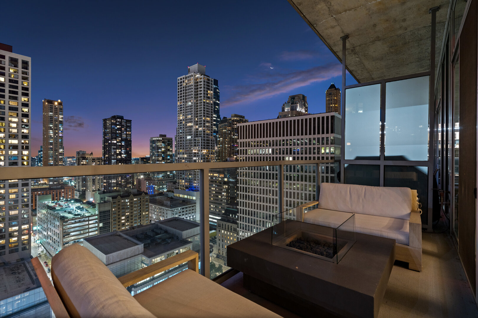 550 North St Clair Street, Unit 2502 Chicago, IL 60611 - Photo 18 of 53 a view of a balcony with couches chairs and wooden floor