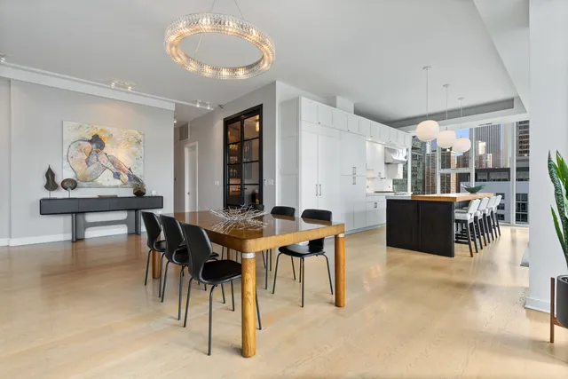 a view of a dining room with furniture and a floor to ceiling window