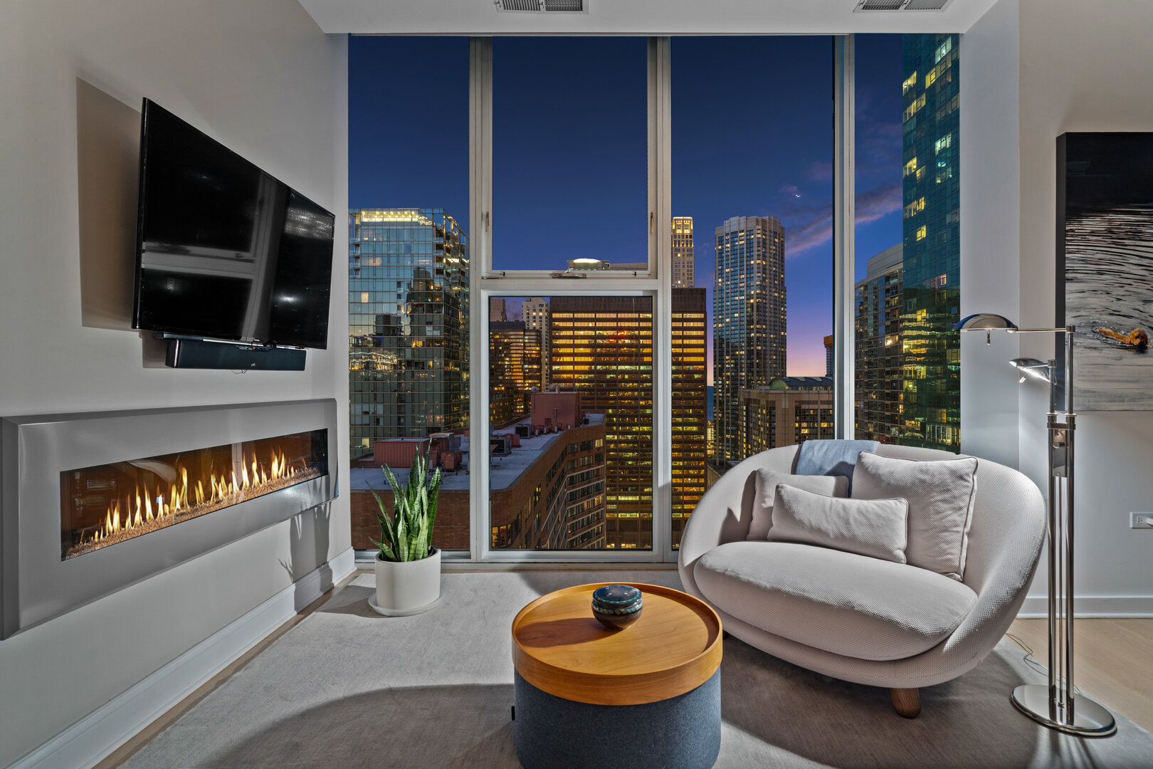 550 North St Clair Street, Unit 2502 Chicago, IL 60611 - Photo 25 of 53 a living room with furniture a flat screen tv and a fireplace