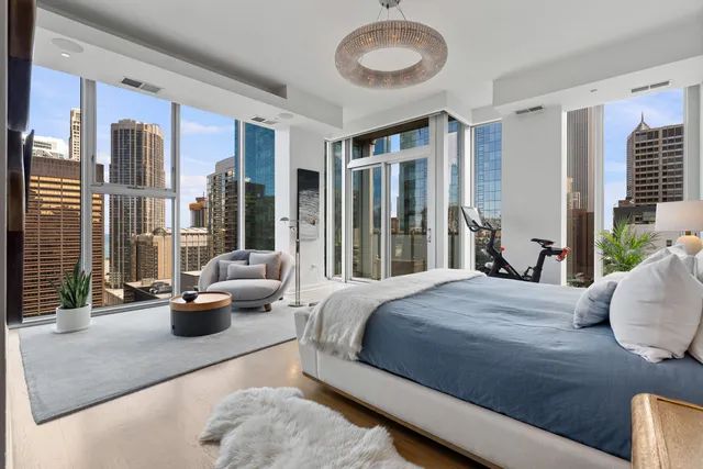 a bedroom with a bed and a potted plant