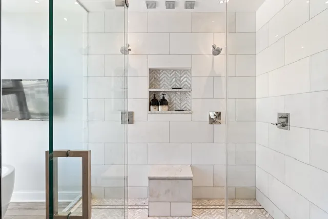 a view of a hallway with wooden floor and windows