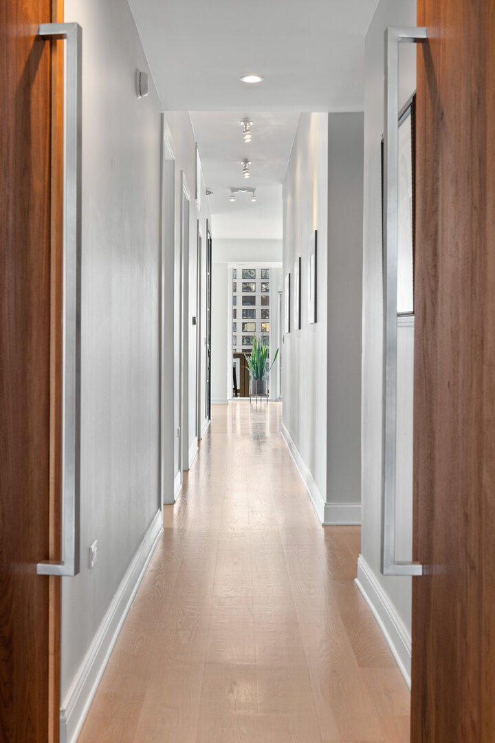 550 North St Clair Street, Unit 2502 Chicago, IL 60611 - Photo 35 of 53 a view of a hallway with wooden floor and windows