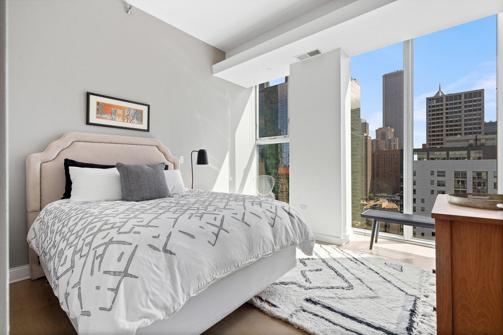 550 North St Clair Street, Unit 2502 Chicago, IL 60611 - Photo 39 of 53 a bedroom with a bed and glass windows