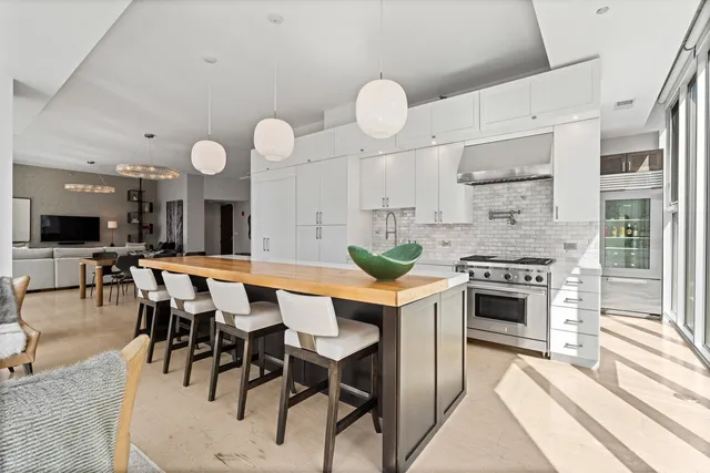 a large kitchen with a table and chairs