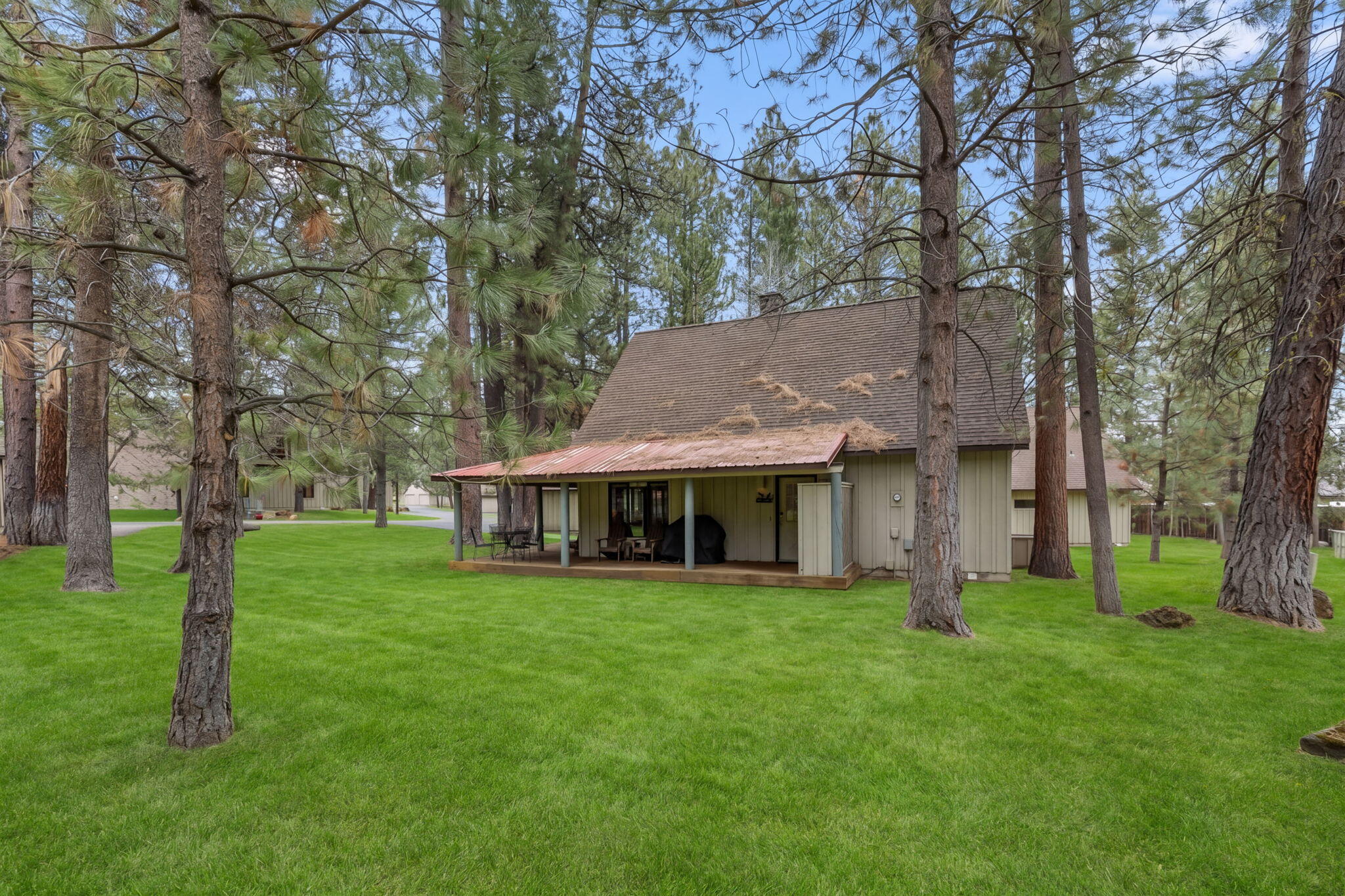 57505 Circle 4 Cabin Road, Unit 29 Sunriver, OR 97707 - Photo 31 of 35 a view of a house with a yard and sitting area