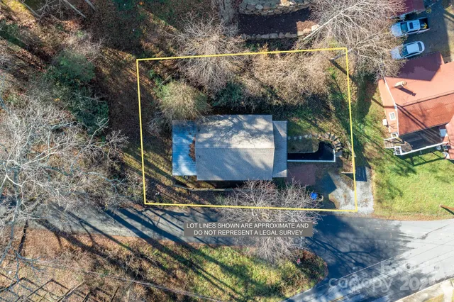 an aerial view of a house with a yard basket ball court and outdoor seating