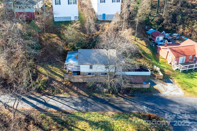 a view of empty room with wooden floor and window