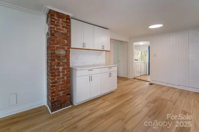 a kitchen with a refrigerator a sink and cabinets