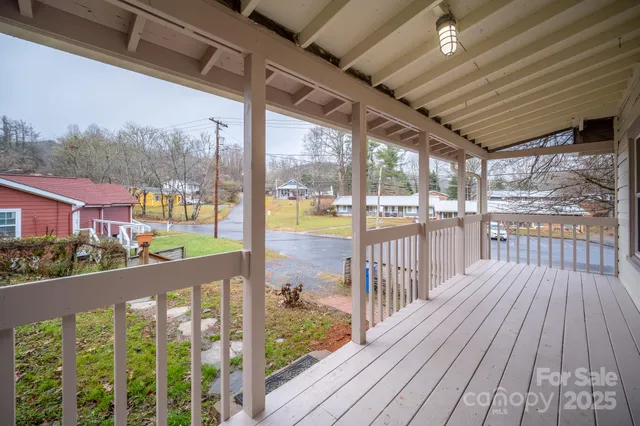 a view of a balcony with wooden floor