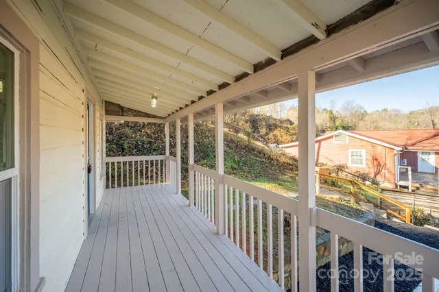 a view of a balcony with wooden floor