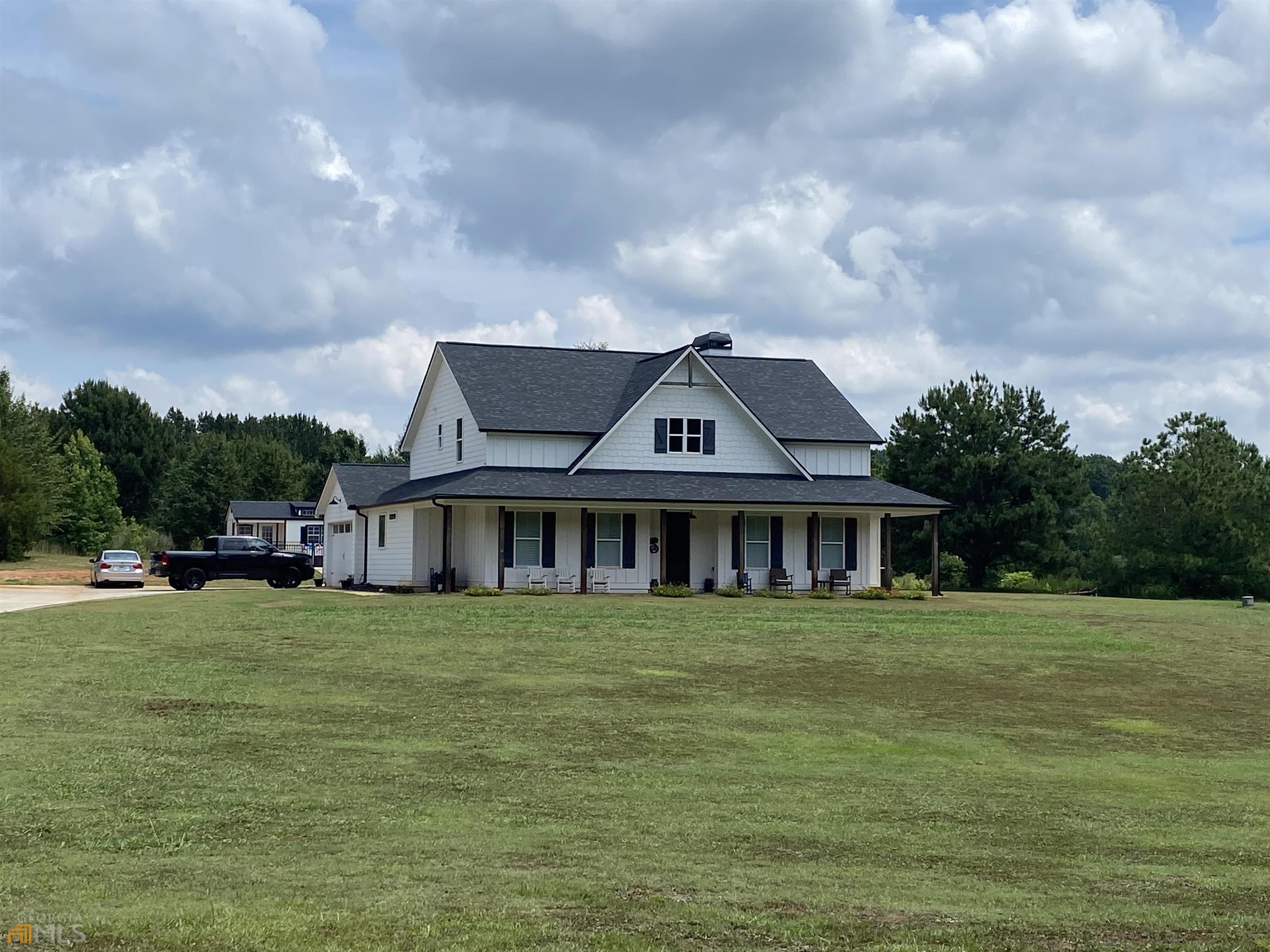 179 Davis Road Jefferson, GA 30549 - Photo 1 of 1 a view of a house with a big yard and large trees