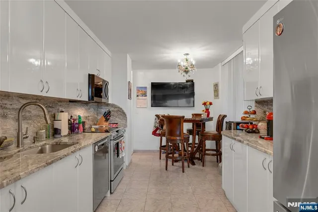 a kitchen filled counter top space a sink cabinets and appliances