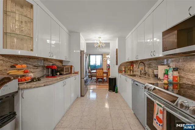 a kitchen with stainless steel appliances a stove and cabinets