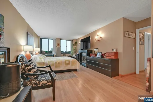 a bed room with a bed window and a mirror