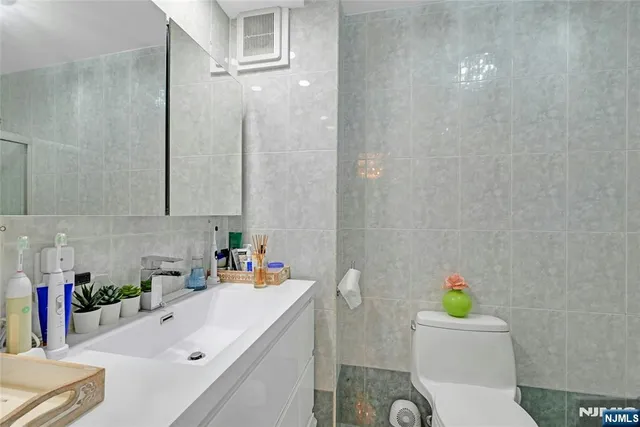 a bathroom with a sink toilet vanity and tub