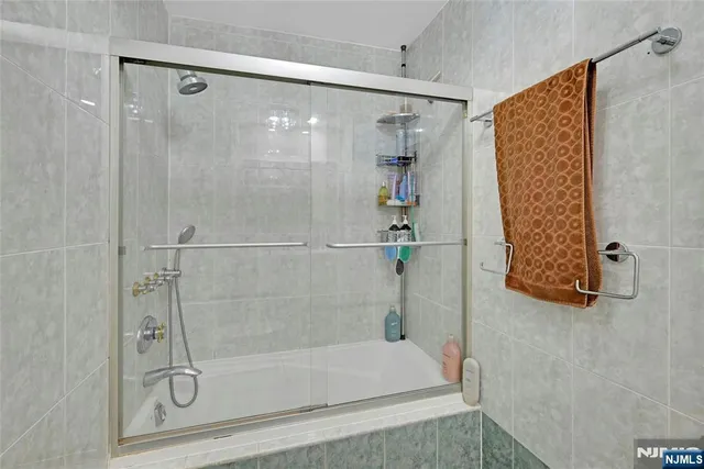 a bathroom with a shower and a bath tub