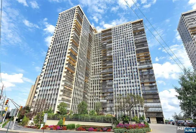 a view of a workspace with furniture and floor to ceiling window