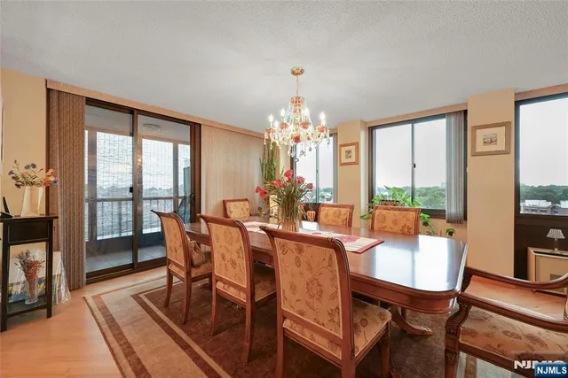 a view of a dining room with furniture large windows and wooden floor