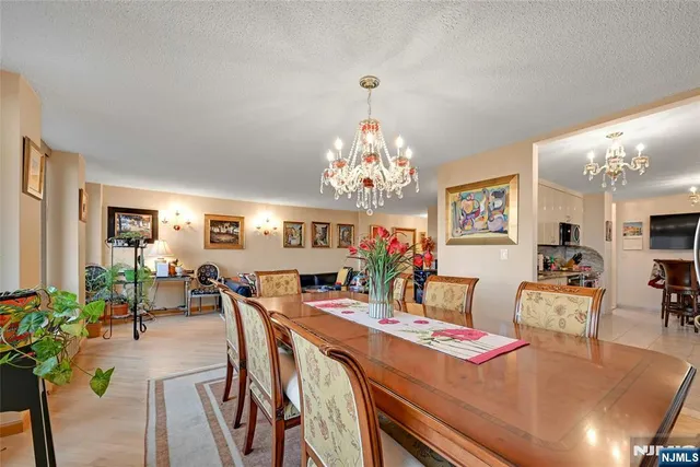 a view of a dining room with furniture and chandelier