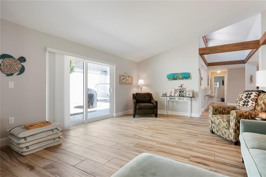 3804 Sun Eagle Lane Bradenton, FL 34210 - Photo 22 of 55 a living room with furniture and a floor to ceiling window