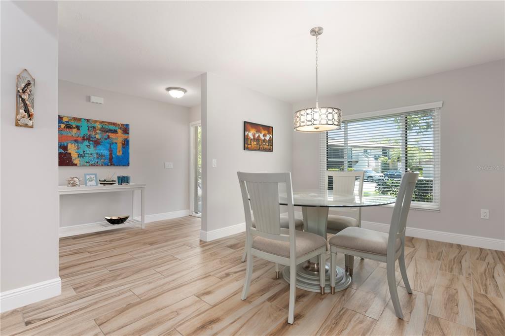 3804 Sun Eagle Lane Bradenton, FL 34210 - Photo 7 of 55 a dining room with furniture a window and wooden floor